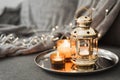 Golden lantern and burning candles on a metal tray. Traditional decor for muslim holidays