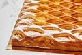 Golden lattice apple pie with custard and powdered sugar