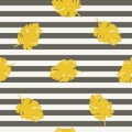 Golden leaf on striped background seamless pattern