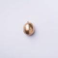 Golden lemon on grey background. Creative food concept. Top view. Flat lay. Single exotic gold fruit