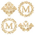 Golden letter M vintage monograms set. Heraldic monogram in coats of arms form, letter M in floral round frame, letter M in wreath