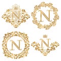 Golden letter N vintage monograms set. Heraldic monogram in coats of arms form, letter N in floral round frame, letter N in wreath