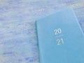 2021 blue leather diary on aqua blue striped textured background. Royalty Free Stock Photo