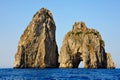 Sea stacks of Capri, Italy. Faraglioni di Fuori Scopolo and Faraglioni di Mezzo with famous archway.