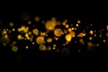 Golden light bokeh and abstract glittering on dark background. Sparkling dust particles