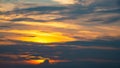 Golden light and dark clouds on sky during sunset. Royalty Free Stock Photo