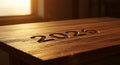 Golden light illuminates 2026 carved into wood table Royalty Free Stock Photo