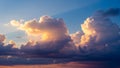 Golden Light Illuminates Dramatic Cumulus Clouds Against a Deep Blue Sky with Sun Rays Royalty Free Stock Photo