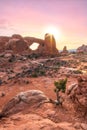 Golden light shining through a natural sandstone arch during sunrise in Arches National Park, Utah. Royalty Free Stock Photo