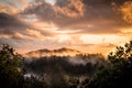 The Golden Light of Sunset over Misty Mountains Royalty Free Stock Photo