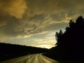 Golden light, wet roads, storm clouds, motorcycles