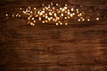 Golden lights on wooden background Royalty Free Stock Photo