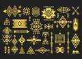 Golden like silhouette trendy Aztec and tribal signs and symbols design elements set on black Royalty Free Stock Photo