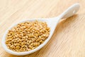 Golden lin seeds or flax seeds in wooden spoon