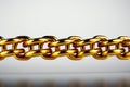 Golden link binds chain, isolated on white background