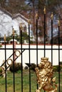 A golden lion on a cast iron gate