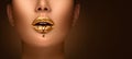 Golden lipstick closeup. Liquid metal dripping from gold lips. Beautiful makeup. Sexy lips, bright liquid paint on girl`s mouth Royalty Free Stock Photo