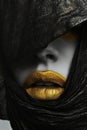 Golden lipstick closeup. Metal gold lips. Beautiful makeup. Sexy lips, bright paint on beautiful model girl's mouth Royalty Free Stock Photo