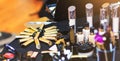 Golden lipstick collection. Big set of cosmetic products lie on table. Real make up kit of professional beautician.