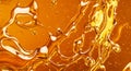 Golden liquid flows with a rich, viscous texture, creating abstract patterns generated