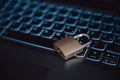 Golden locked padlock lying on a black laptop computer keyboard Royalty Free Stock Photo