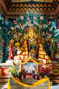 Golden Lord Buddha statue in Bhutanese style inside The Royal Bhutanese Monastery in Bodh Gaya, Bihar, India