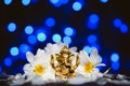 Golden lord ganesha sculpture in daisy flowers over blue illuminated background. Celebrate lord ganesha festival Royalty Free Stock Photo