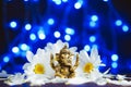 Golden lord ganesha sculpture in daisy flowers over blue illuminated background. Celebrate lord ganesha festival Royalty Free Stock Photo