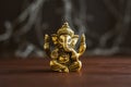 Golden lord Ganesha sculpture over blue illuminated background. Celebrate lord Ganesha festival Royalty Free Stock Photo