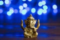 Golden lord Ganesha sculpture over blue illuminated background. Celebrate lord Ganesha festival Royalty Free Stock Photo