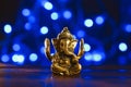 Golden lord ganesha sculpture over blue illuminated background. Celebrate lord ganesha festival Royalty Free Stock Photo