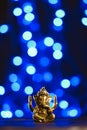 Golden lord ganesha sculpture over blue illuminated background. Celebrate lord ganesha festival Royalty Free Stock Photo