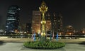 Golden lotus statue against modern buildings