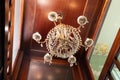 Golden luxury chandelier with crystal pendants. Ceiling luster with diamond shaped glass gems. View from below. St Petersburg,