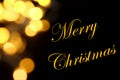 Gold Christmas lights soft focus bokeh background with Merry Christmas Royalty Free Stock Photo