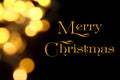 Gold Christmas lights soft focus bokeh background with Merry Christmas Royalty Free Stock Photo