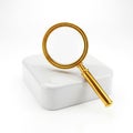 Golden magnifying glass on white surface isolated on white background Royalty Free Stock Photo