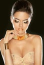 Golden Makeup. Fashion beautiful young girl in luxurious beige d