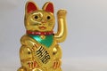 Golden Maneki Neko Japan lucky cat paw in motion