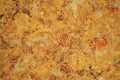 Golden marble with small inclusions of white and gray, close-up of polished Plao surface of natural stone Royalty Free Stock Photo