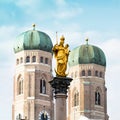 The Golden Mary's Column opposite the towers of the Cathedral of Our Dear Lady in Munich, Germany Royalty Free Stock Photo