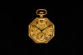Golden mechanical antique pocket watch on black isolated background. Retro pocketwatch with second, minute and hour hand