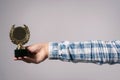 Golden medal award trophy in female hand Royalty Free Stock Photo