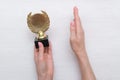 Golden medal trophy in hand. Royalty Free Stock Photo