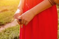 Golden mehendi tattoo on woman& x27;s hands in red dress Royalty Free Stock Photo