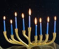Golden menorah with nine blue candles