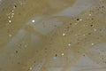 Golden mesh fabric chiffon organza with glitter. Golden background Royalty Free Stock Photo