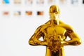 Hollywood Golden Oscar Academy award statue in medical mask. Success and victory concept. Oscar ceremony in coronavirus time