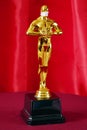 Hollywood Golden Oscar Academy award statue in medical mask. Success and victory concept. Oscar ceremony in coronavirus time