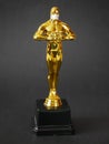 Hollywood Golden Oscar Academy award statue in medical mask. Success and victory concept. Oscar ceremony in coronavirus time